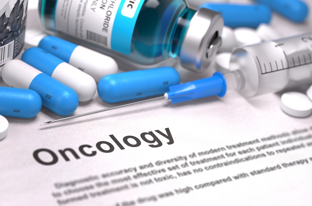 Oncology - Printed Diagnosis with Blue Pills, Injections and Syringe. Medical Concept with Selective Focus.